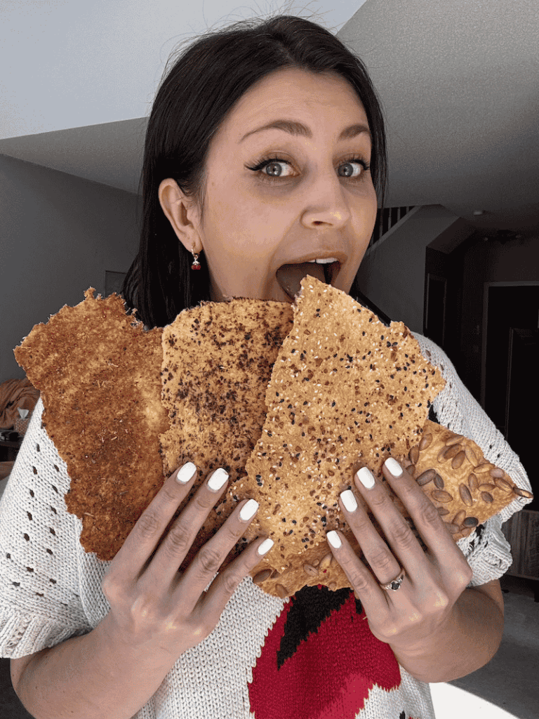 Woman holding 4 types of lavash crackers like a fan